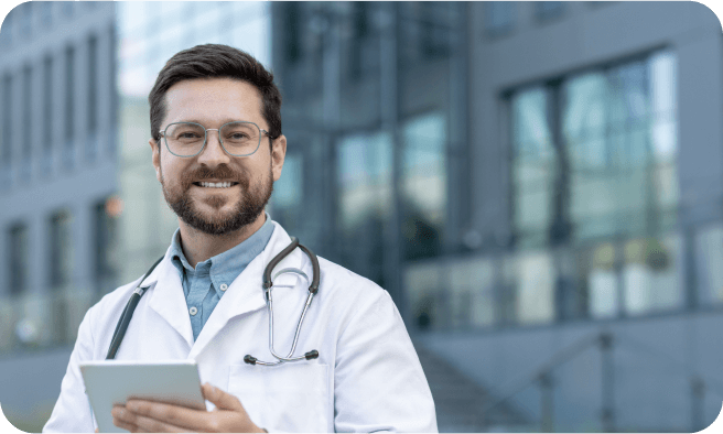 Doctor smiling and looking at paperwork